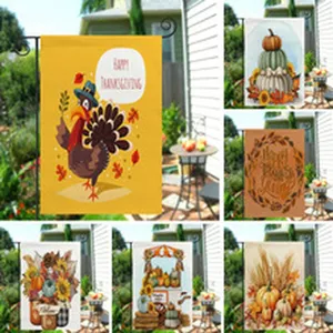 Detailed view of autumn garden flags featuring Thanksgiving turkey, pumpkins, and seasonal floral designs.