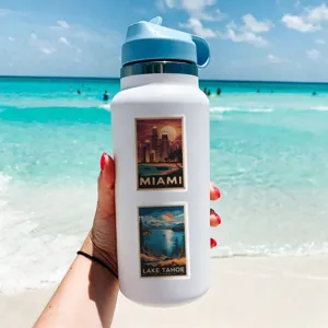 Waterproof retro travel poster stickers shown applied on a tumbler, beach scene detail.