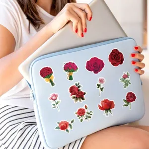 Detail view of waterproof red rose stickers decorating a laptop sleeve for aesthetic appeal.
