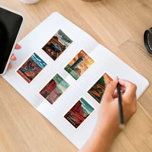 Detail view of vintage American landscape stickers placed on a notebook for decoration.