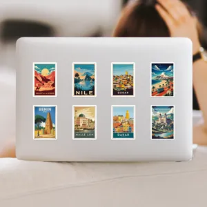 Detail view of waterproof African travel theme vintage poster stickers pasted on a laptop.