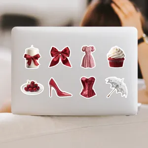 Close-up detail showing red aesthetic waterproof stickers arranged on a white laptop surface.