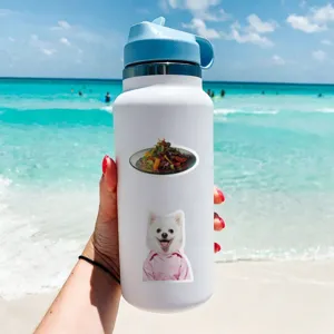 Close-up detail of white water bottle decorated with cute animal stickers on beach background.