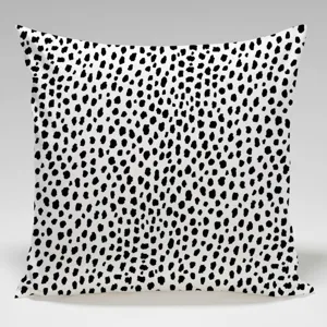 Detailed view of the black and white abstract dotted throw pillow cover, soft fabric texture.