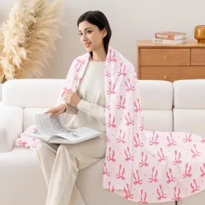 Cozy pink bow print flannel blanket, soft throw blanket for couch, living room decor.