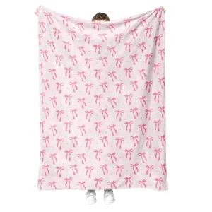 Cozy pink flannel blanket featuring an adorable bow pattern, soft and warm for daily home use.