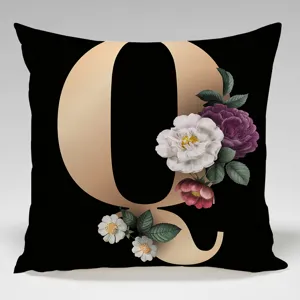 Close-up detail of luxury black and gold letter Q floral throw pillowcase, vintage style.