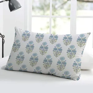 Dettaglio di federa per cuscino rettangolare in lino bianco con motivo floreale blu per casa.