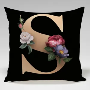 Close-up of the elegant black throw pillow featuring a luxury gold letter S and vintage roses.