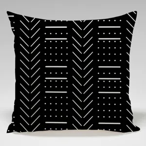 Detail shot of a modern black throw pillow with white geometric pattern for sofa decor.