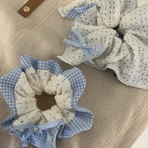 Detail shot of blue plaid lace scrunchie with cute bow and pearl, sweet hair accessory.