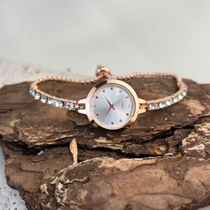 Elegant rose gold rhinestone quartz watch for women with adjustable crystal bracelet strap.