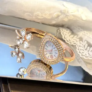 Elegant clover teardrop bangle watch with sparkling crystals and quartz movement for women.