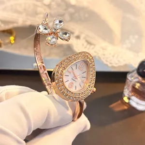 Close-up detail of the elegant rose gold quartz watch featuring a crystal clover and teardrop dial.