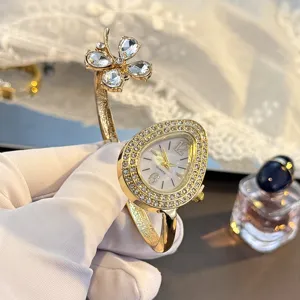 Luxury four-leaf clover waterdrop quartz bangle watch with shiny sparkling stones.