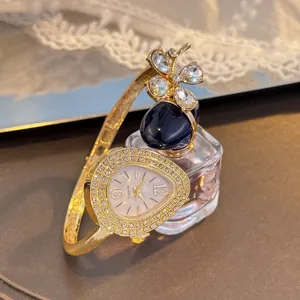 Luxury clover teardrop quartz watch for women, elegant open bangle design with sparkling crystals.