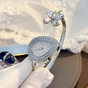 Detailed view of women quartz watch featuring a teardrop rhinestone dial and clover bangle.