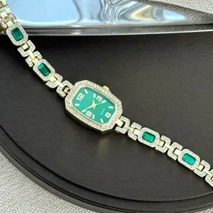 Exquisite women quartz watch detail, green dial with diamond encrusted gemstone bracelet links.