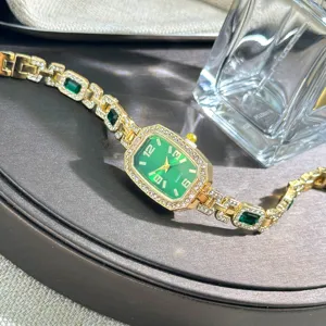 Elegant women's green dial quartz watch with sparkling rhinestones, stylish bracelet design.