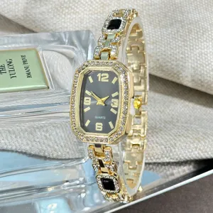 Detail shot of a women's luxury gold quartz watch with rhinestones, elegant octagonal dial.