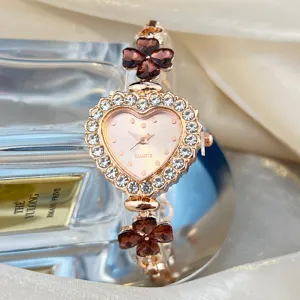 Exquisite heart-shaped quartz watch with sparkling rhinestones and crystal clover details.