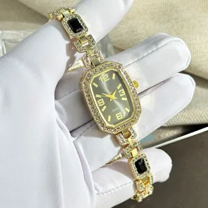 Elegant women quartz watch with rhinestones and black gems, stylish golden bracelet design.