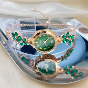 Women's rose gold quartz watch with green stone flower bracelet strap and round dial.