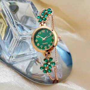 Close-up of elegant green dial quartz watch with sparkling crystal flower bracelet strap.
