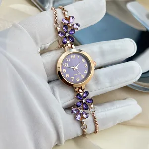 Elegant women's quartz watch with purple crystal flower charm, rose gold adjustable chain.
