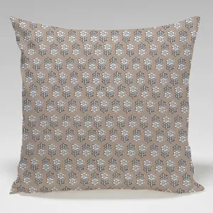 Close-up detail of a square throw pillow cover featuring a white floral block print pattern.