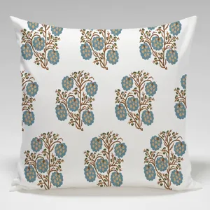 Close-up detail of white linen cushion cover featuring traditional blue floral block print design.