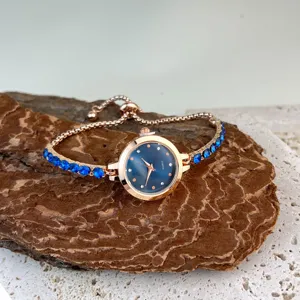 Exquisite women crystal quartz watch with blue rhinestone bracelet, elegant adjustable design.