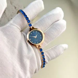 Women quartz watch featuring blue crystal bracelet and rose gold finish for chic wear.