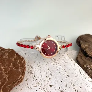 Elegant women quartz watch featuring a red dial and sparkling rhinestone bracelet strap design.