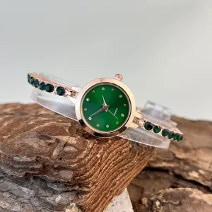 Women's green dial quartz watch with sparkling rhinestone bracelet, elegant rose gold finish.