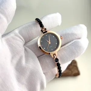Close-up detail of the women rose gold quartz watch with black beaded rhinestone bracelet.