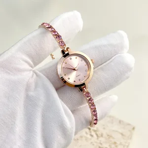 Elegant women's quartz watch featuring pink crystal rhinestone strap and sleek rose gold finish.
