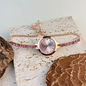 Close-up detail of a rose gold women quartz watch with pink crystal bracelet and adjustable chain.