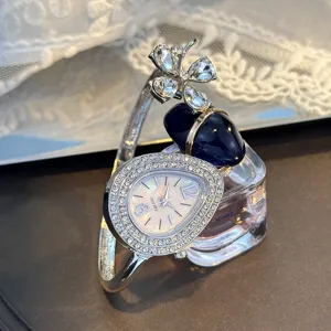 Silver rhinestone teardrop bangle watch with clover and blue stone, elegant women quartz watch.