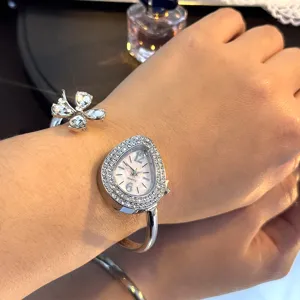 Elegant diamond teardrop watch and clover bangle set featuring quartz movement for women.