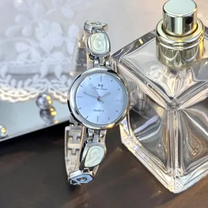 Detailaufnahme einer eleganten silbernen Quarzdamenuhr mit unregelmäßigem Gliederarmband.