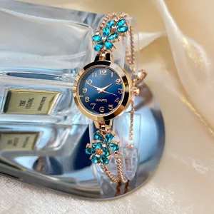 Detailed view of women rhinestone flower quartz watch, rose gold case, blue dial, elegant design.