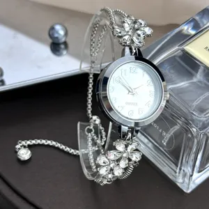 Rhinestone flower bracelet watch detail shot, elegant quartz wristwatch with adjustable pull chain.