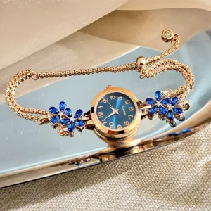Close-up detail view of the rose gold quartz bracelet watch with blue flower crystals.