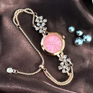 Rose gold quartz women watch with floral rhinestone charm and pink dial for daily wear.