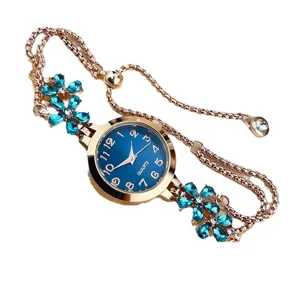 Women's quartz watch with blue dial rose gold bracelet strap and dazzling rhinestone flowers.