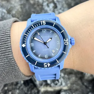 Detailansicht der blauen Silikon-Quarzuhr am Handgelenk mit Zifferblatt und Lünette.
