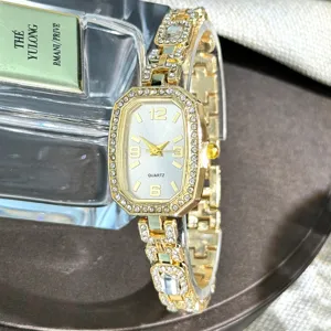 Elegant women gold quartz watch with sparkling rhinestones, luxury oval fashion wristwatch.
