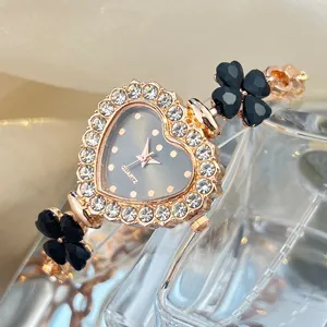Women fashion quartz watch with heart shaped rhinestone dial and black clover bracelet.