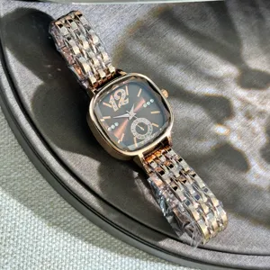 Women quartz watch with square faceted glass dial and rose gold metallic bracelet band.